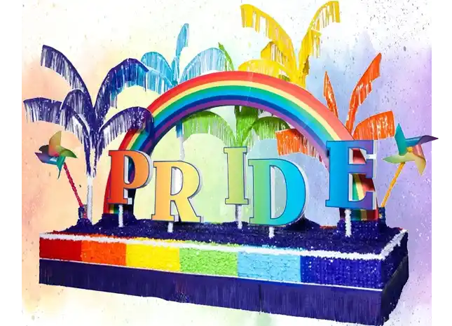 Colorful Pride parade float featuring rainbow letters, a curved rainbow arch, and vibrant fountain sprays in bright colors.