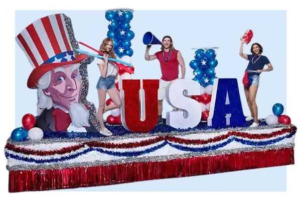 Patriotic USA parade float with red, white, and blue letters, balloon columns, and Uncle Sam artwork on a striped fringe base.