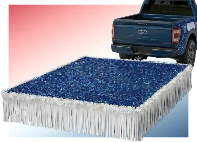 Pickup truck pulling a rectangular parade float platform with blue tinsel and white fringe skirting