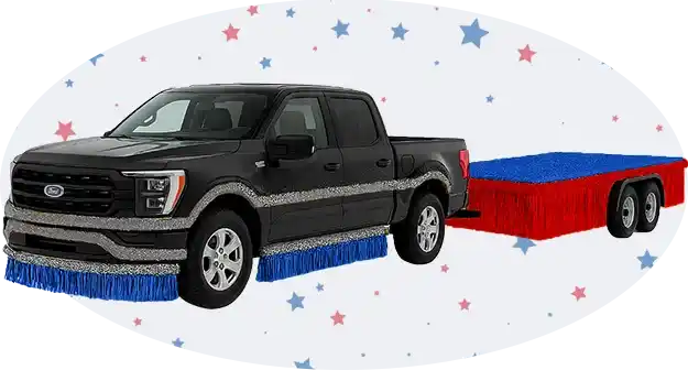 Pickup truck towing a red, white, and blue parade float trailer with fringe trim, shown against a patriotic star backdrop.
